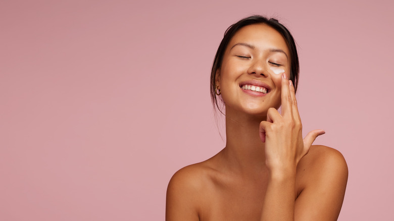 woman applying skin cream