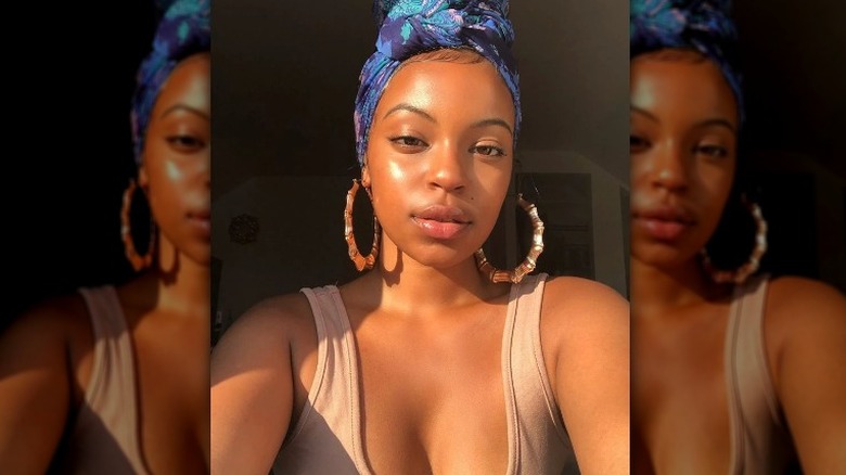 Woman models stained-glass makeup