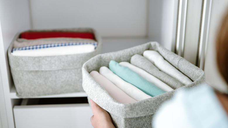 Clothing stored in boxes.