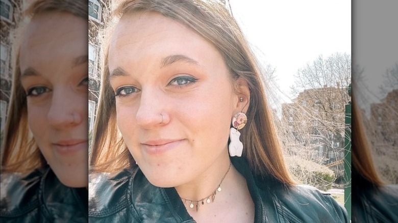 A woman wearing female body earrings