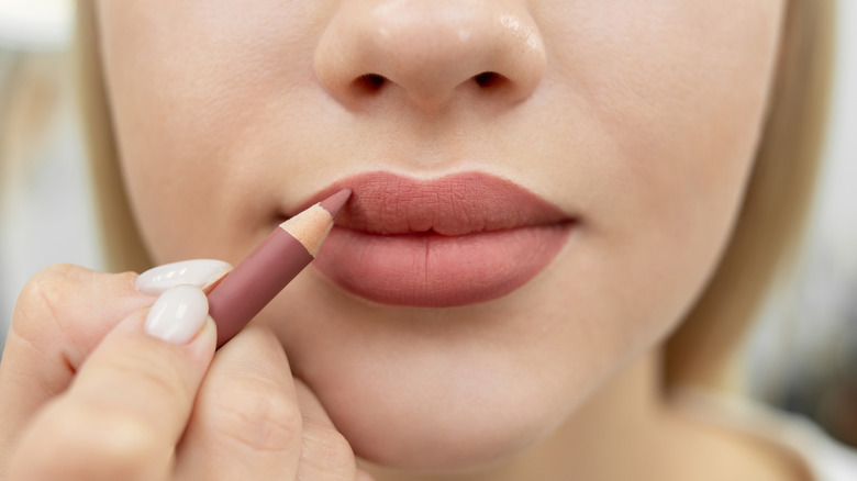 woman applying lip liner