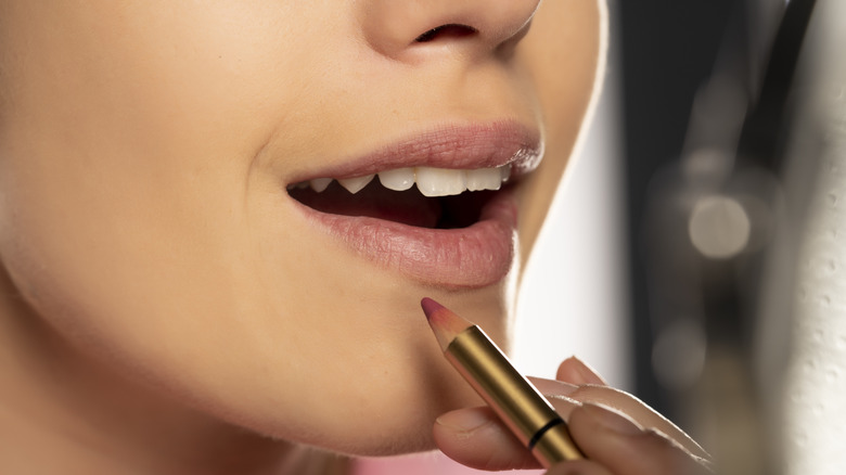 woman applying lip liner
