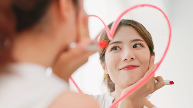 woman with mirror lipstick heart