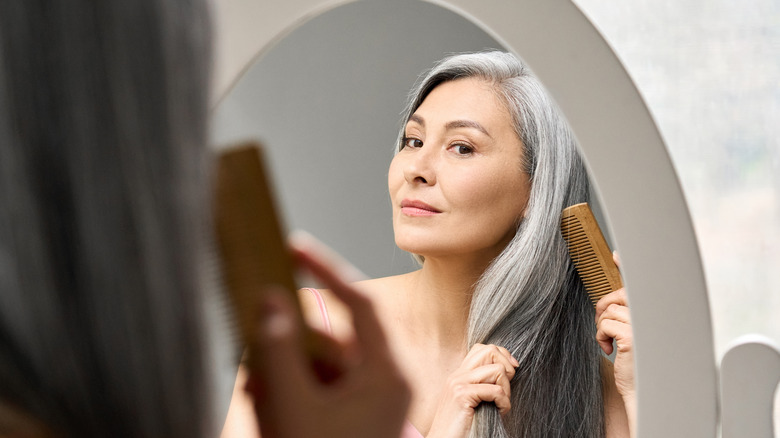 woman combing straight hair