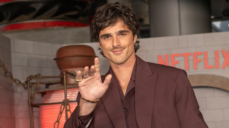 Jacob Elordi walking in a copper suit