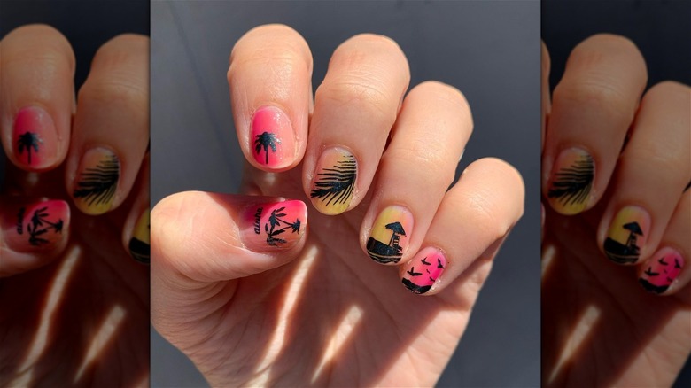 hand with tropical strawberry lemonade nails