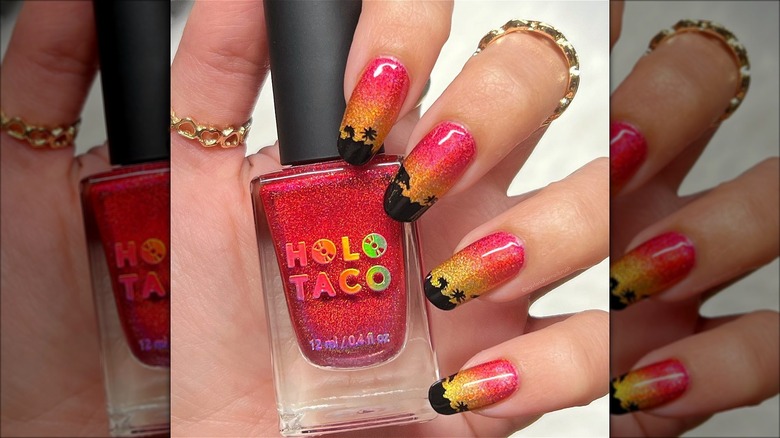 hand with sparkly sunset pink lemonade nails