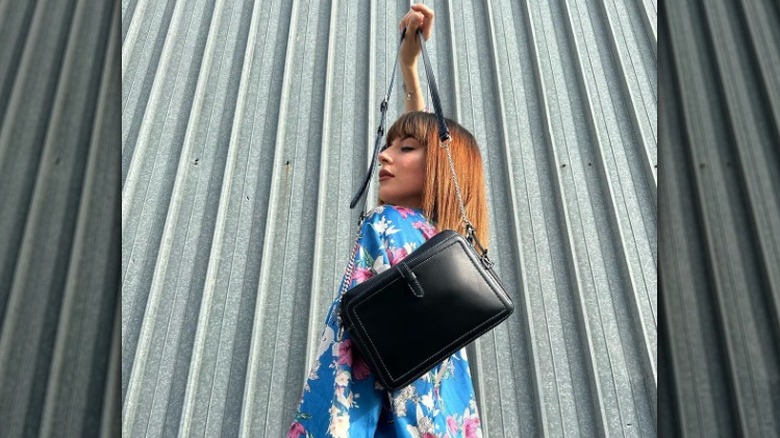 woman holding a structured handbag