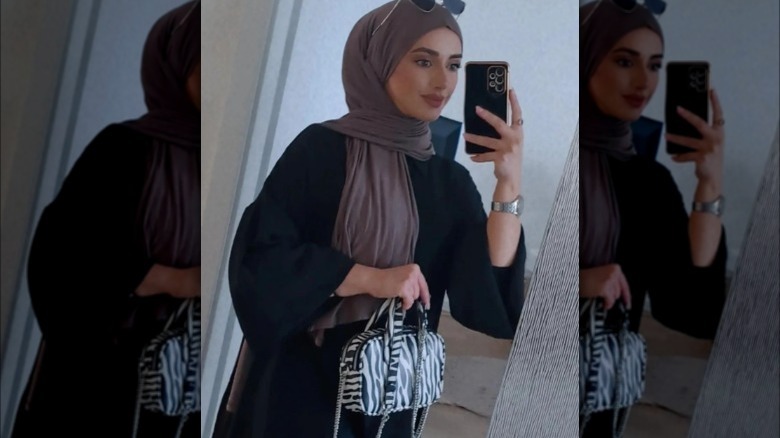 woman holding a structured handbag