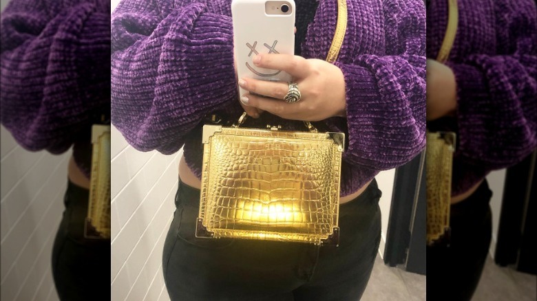 woman holding a structured handbag