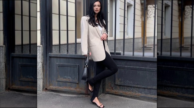 A woman wearing black strappy sandals
