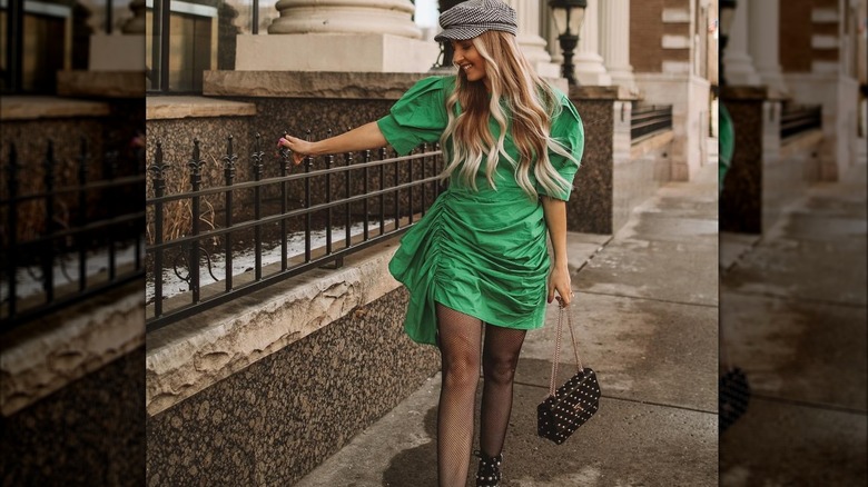 Girl wearing a studded flap bag