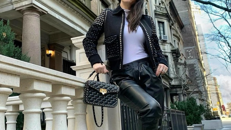 Girl carrying a studded handbag
