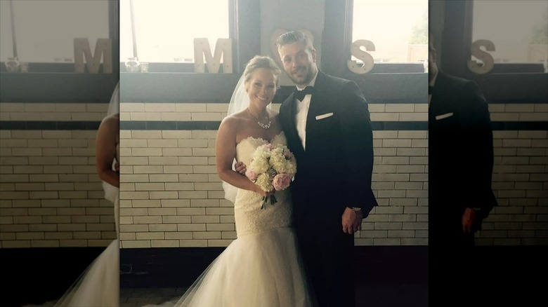 Mina Starsiak Hawk in her wedding dress with her husband