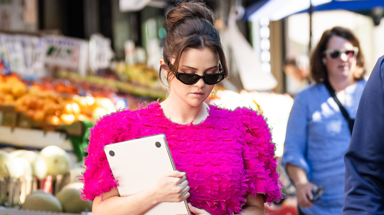 Selena Gomez wearing a pink dress