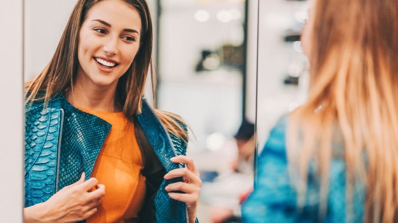 woman trying on coat