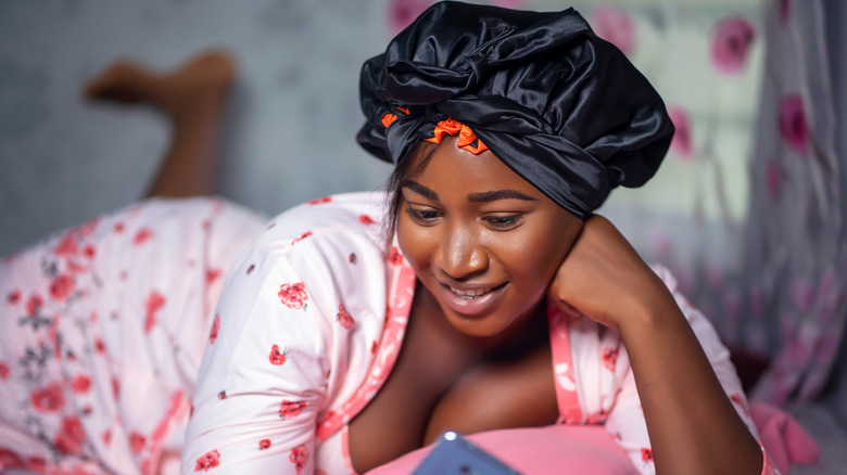 A woman with a satin bonnet