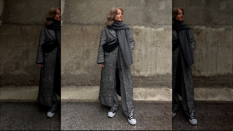 woman wearing long trench coat and trousers