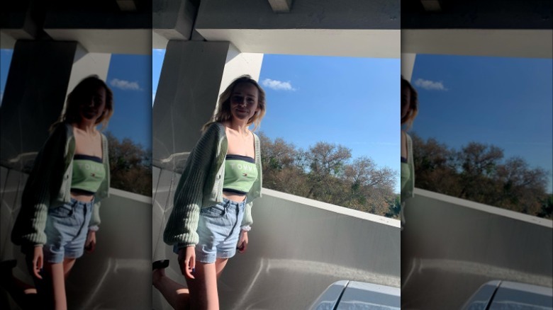 Woman wearing cardigan over crop top