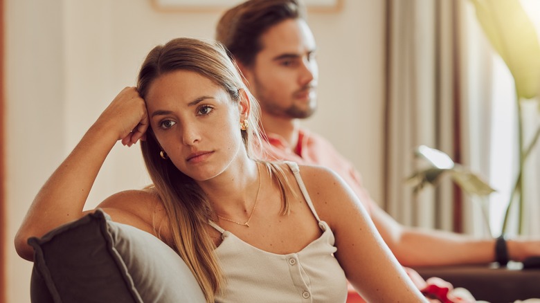 Sad woman sitting next to her partner 