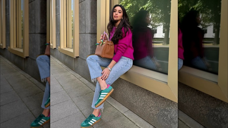woman sitting on windowsill 