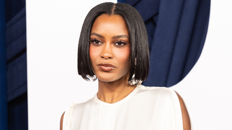 Ciara Miller posing with a sleek bob and a full face of makeup