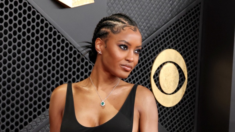 Close-up image of Ciara Miller posing on the Grammys red carpet.