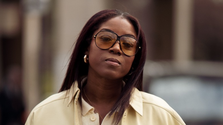 Woman in rounded orange sunglasses