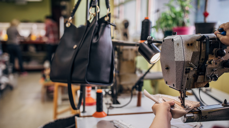 person sewing bag