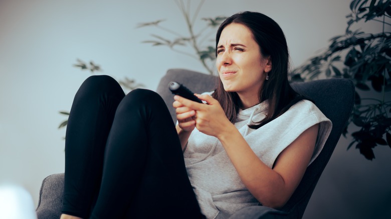 woman squinting at television