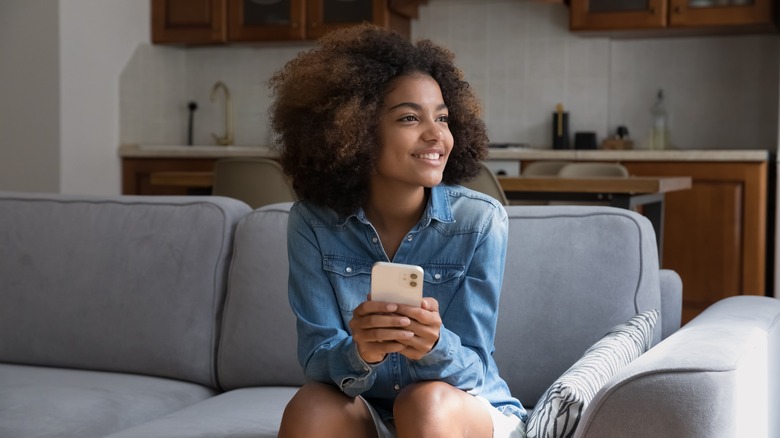 woman holding cell phone