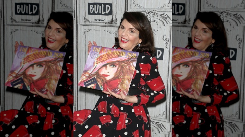 Susan Miller smiling with her calendar