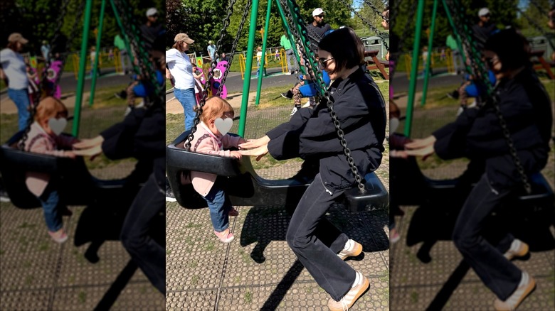 Lily Collins and her daughter play at a park.