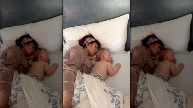 Sharon Osbourne and her grandson Sidney sleeping in bed