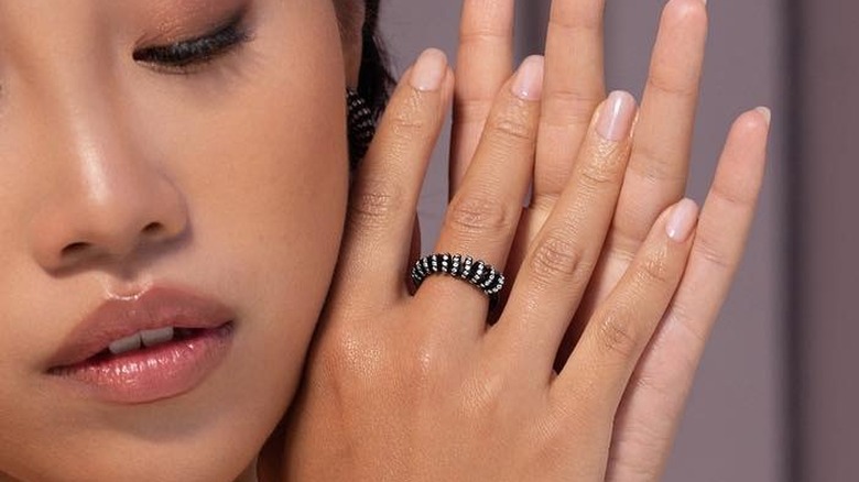 woman wearing black gold ring