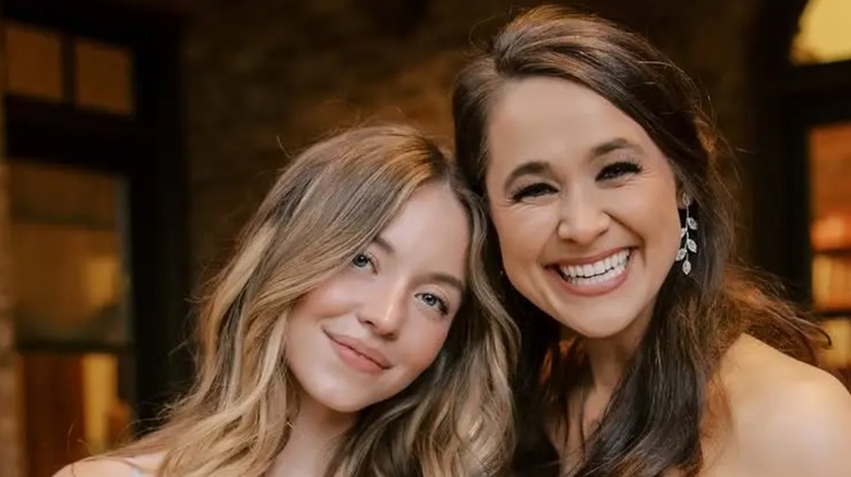Sydney Sweeney and Leslie Powell hugging in their wedding attire at the latter's wedding