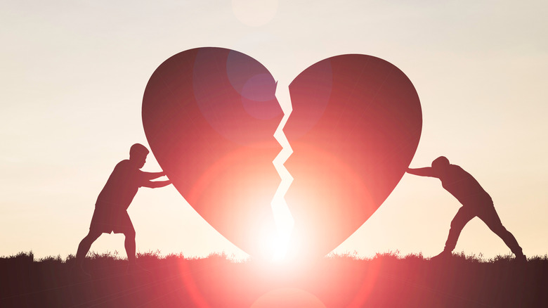 Couple putting broken heart together