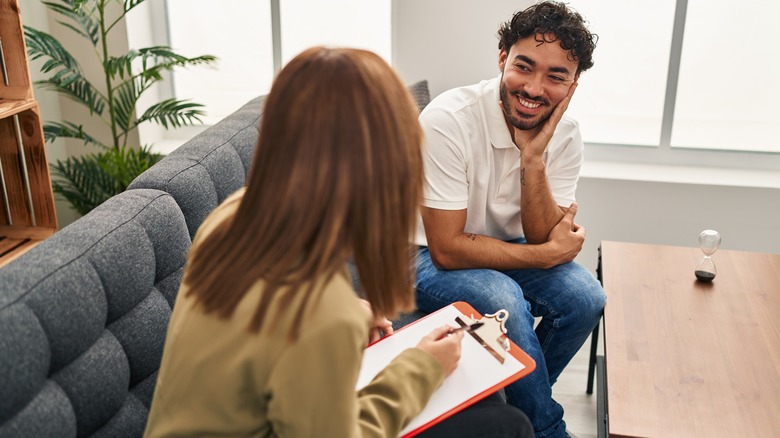 woman talking to guy with check list
