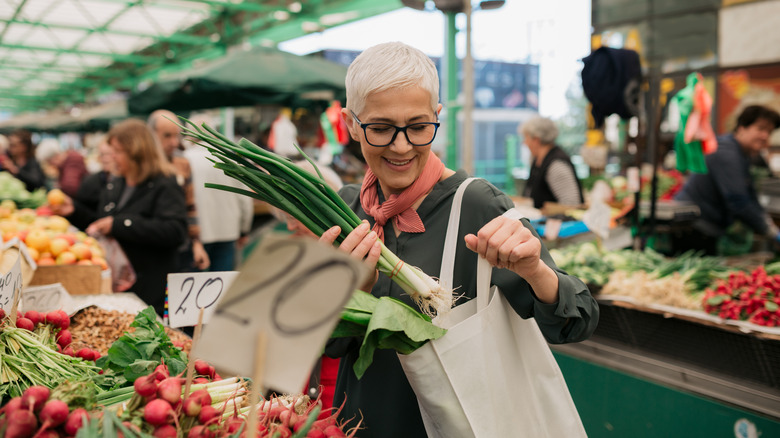 person buying vegetables