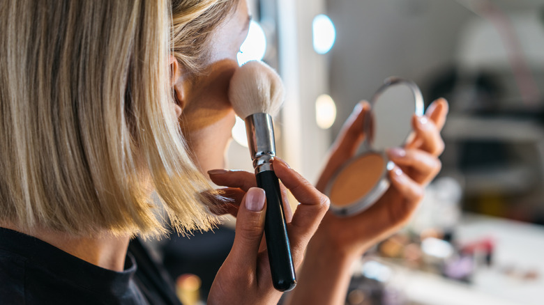woman applying powder