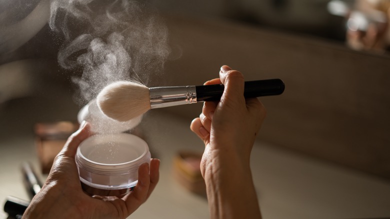 powder makeup spraying dust