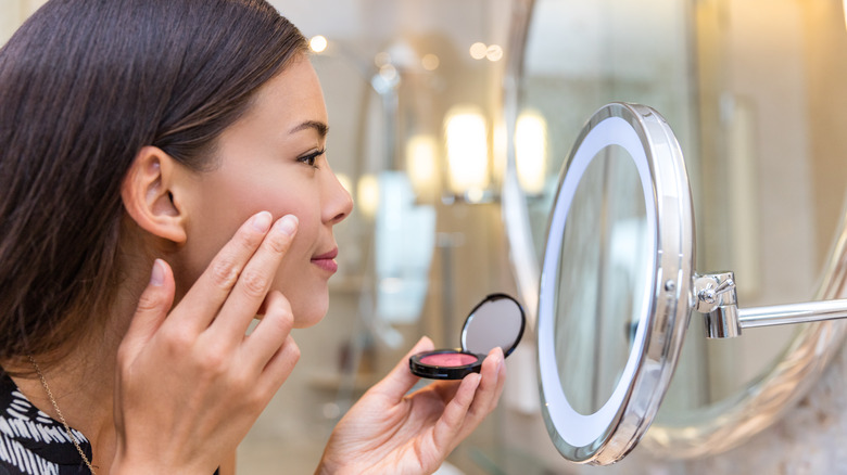 person applying cream blush