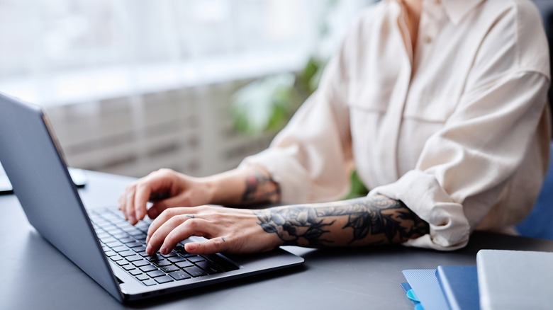person typing on keyboard