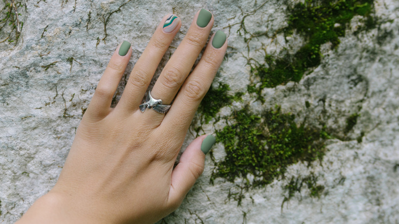Moss green nails near moss