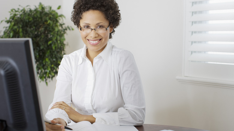 Accountant smiles behind a desk