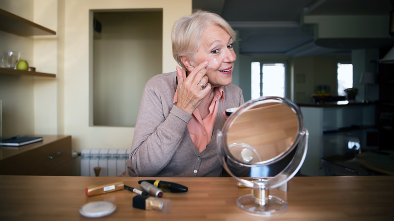Woman applying moisturizer