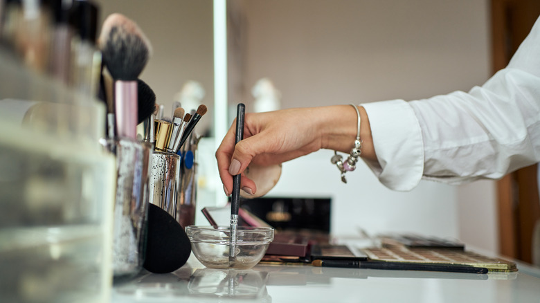 Makeup artist cleaning one of their brushes
