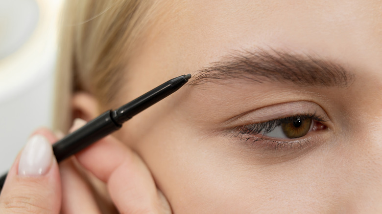 Closeup of eyebrow pencil and eyebrow