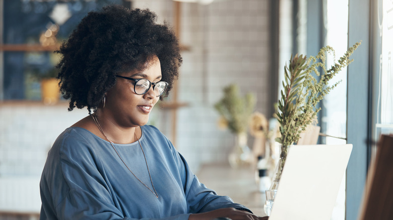 Woman typing at laptop