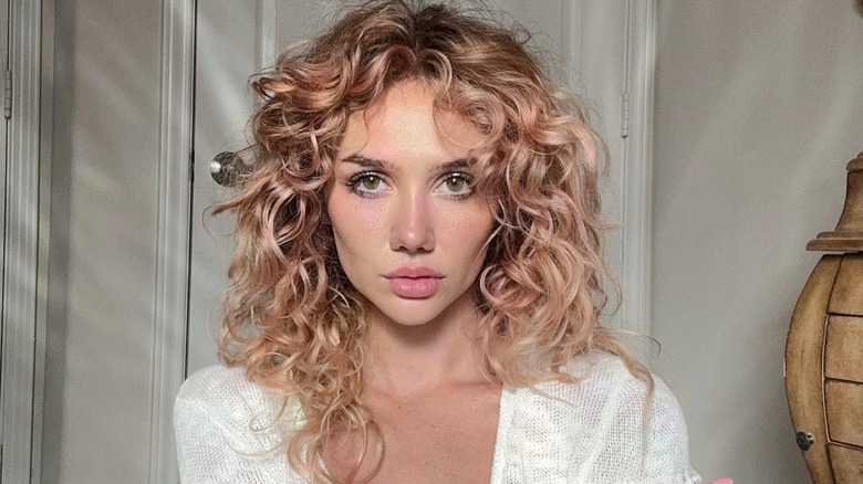 woman with short curly bang tendrils